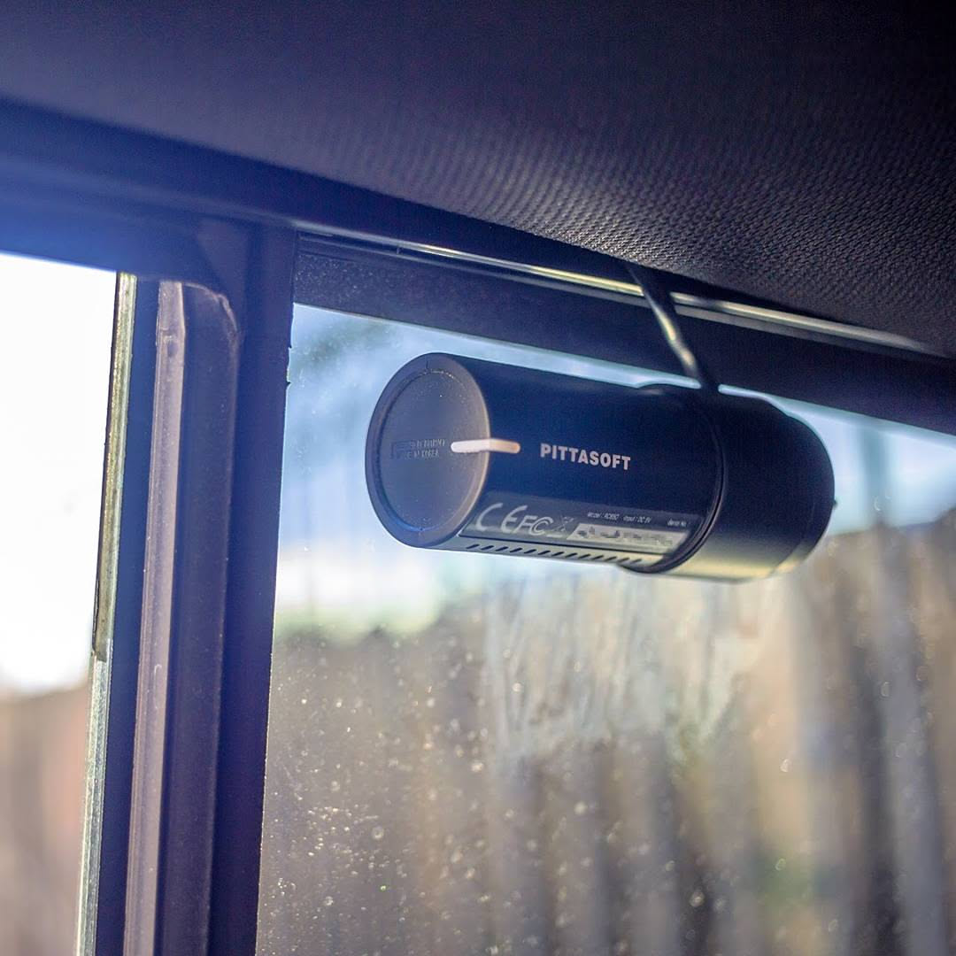 Rear Blackvue camera mounted inside a vehicle on the back windshield.